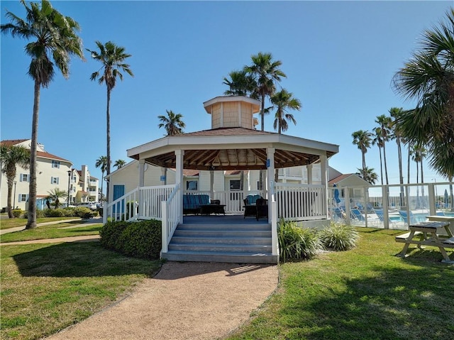 view of home's community with a swimming pool, a lawn, and a gazebo