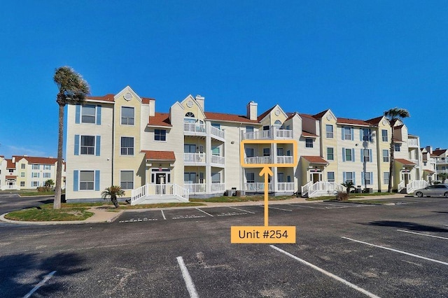 view of property featuring uncovered parking