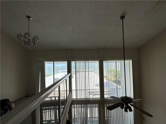 3402 Ocean Dr Unit 8, Corpus Christi, TX 78411 - detailed view of a textured ceiling, a chandelier, and a ceiling fan