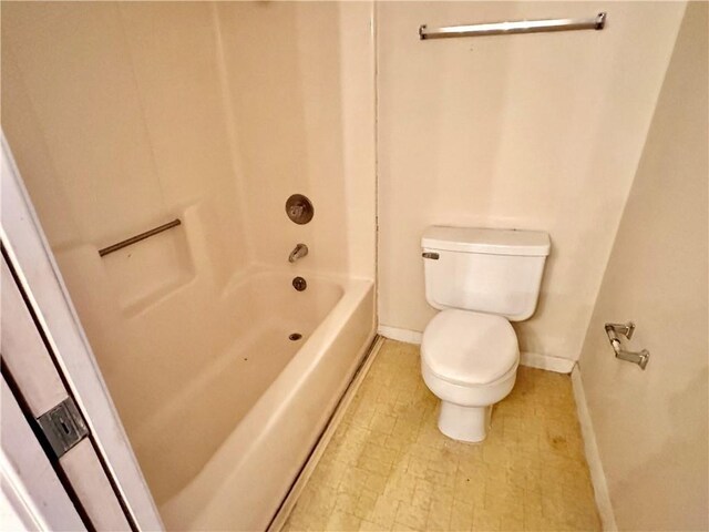 3402 Ocean Dr Unit 8, Corpus Christi, TX 78411 - bathroom featuring toilet, baseboards, and shower / bath combination