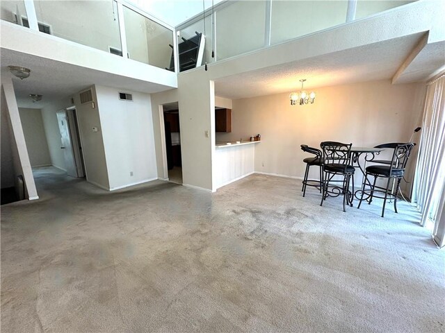 3402 Ocean Dr Unit 8, Corpus Christi, TX 78411 - carpeted dining space with baseboards, a chandelier, and a towering ceiling