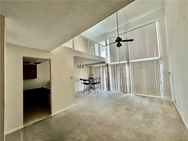 3402 Ocean Dr Unit 8, Corpus Christi, TX 78411 - carpeted empty room with ceiling fan, baseboards, and a textured ceiling