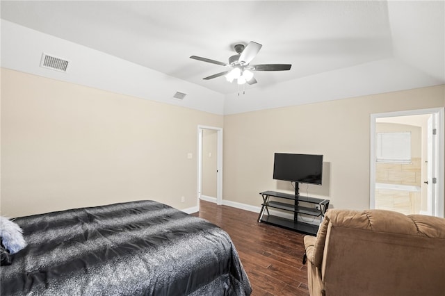 bedroom with dark wood-type flooring, baseboards, visible vents, and lofted ceiling