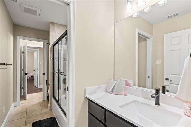 bathroom with tile patterned flooring, visible vents, baseboards, combined bath / shower with glass door, and vanity