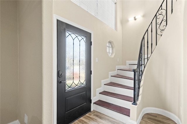 foyer with stairs, light wood-style flooring, and a healthy amount of sunlight