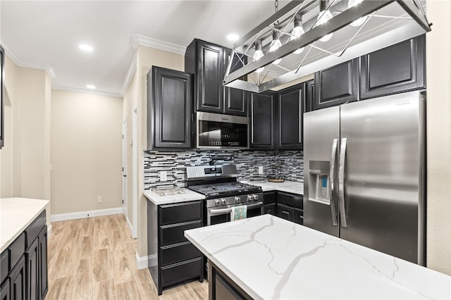 kitchen with light stone counters, appliances with stainless steel finishes, crown molding, dark cabinets, and backsplash