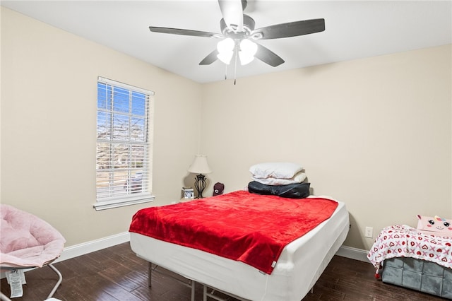 bedroom featuring baseboards, wood-type flooring, and ceiling fan