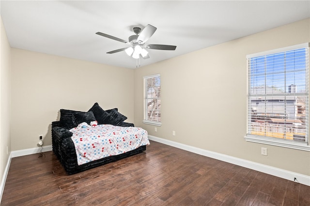 bedroom featuring wood finished floors and baseboards