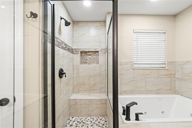 full bathroom featuring a tub with jets and a stall shower