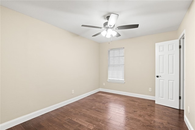 empty room with baseboards, dark wood-style floors, and a ceiling fan