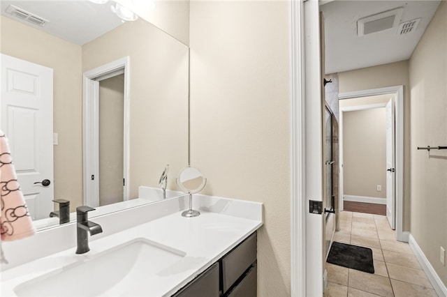 bathroom featuring tile patterned flooring, visible vents, vanity, and baseboards