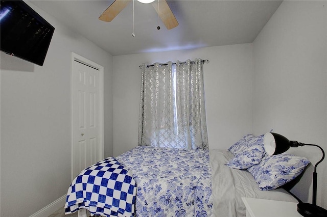 bedroom featuring ceiling fan and a closet