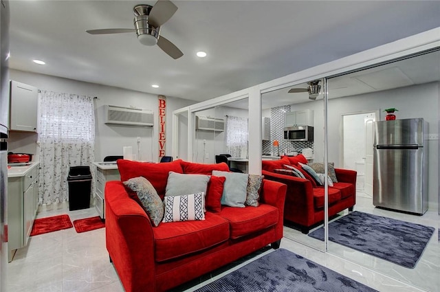 living room featuring ceiling fan and a wall mounted AC