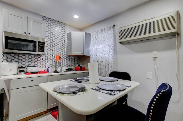 5434 Alejandro St, Corpus Christi, TX 78415 - kitchen with stainless steel microwave, a wall mounted air conditioner, light countertops, and recessed lighting