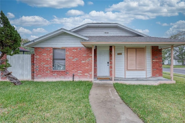 5434 Alejandro St, Corpus Christi, TX 78415 - view of front of house featuring a front lawn, brick siding, and a porch