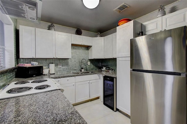 kitchen with stainless steel refrigerator, white cabinetry, sink, beverage cooler, and decorative backsplash