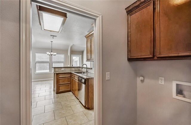 4376 Summer Wind Dr, Corpus Christi, TX 78413 - laundry room featuring a chandelier, light tile patterned flooring, washer hookup, cabinet space, and gas dryer hookup
