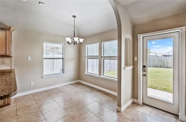 4376 Summer Wind Dr, Corpus Christi, TX 78413 - unfurnished dining area with plenty of natural light, a chandelier, arched walkways, and light tile patterned flooring