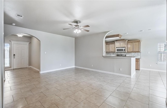 4376 Summer Wind Dr, Corpus Christi, TX 78413 - unfurnished living room featuring a ceiling fan, arched walkways, and light tile patterned floors