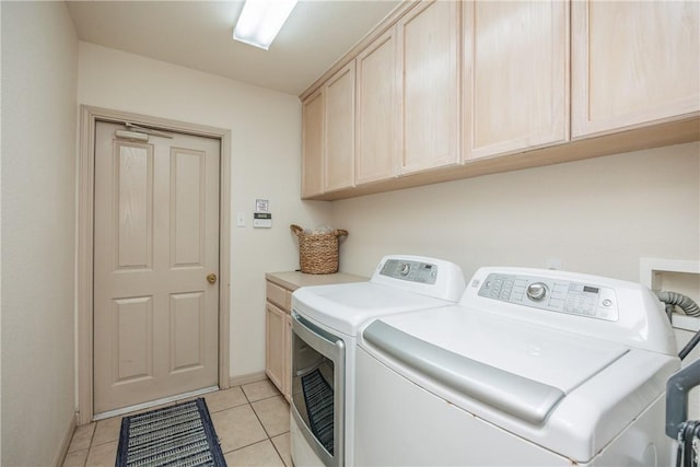 laundry area with cabinets, independent washer and dryer, and light tile patterned floors