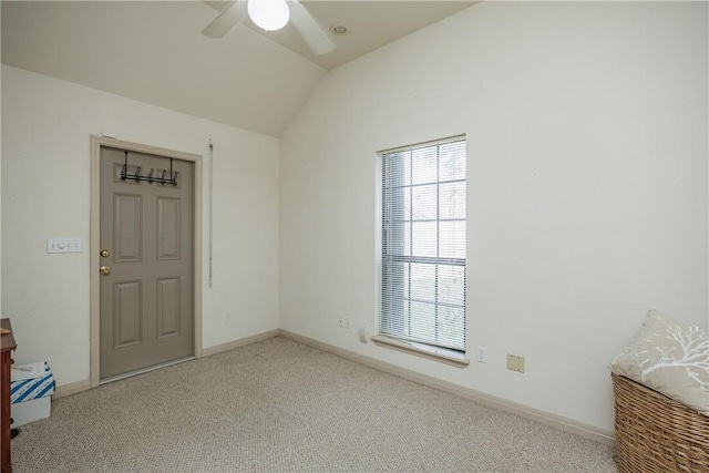 empty room featuring lofted ceiling, light colored carpet, ceiling fan, and baseboards