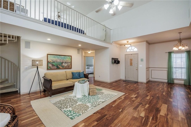 living area with a towering ceiling, baseboards, visible vents, and dark wood-type flooring