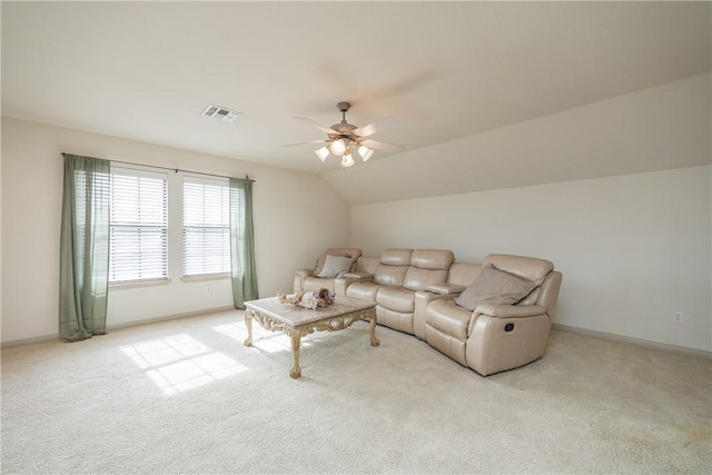 living area featuring light carpet, baseboards, visible vents, and lofted ceiling