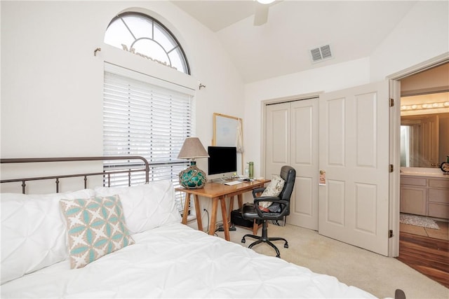 bedroom with multiple windows, light carpet, ceiling fan, and a closet