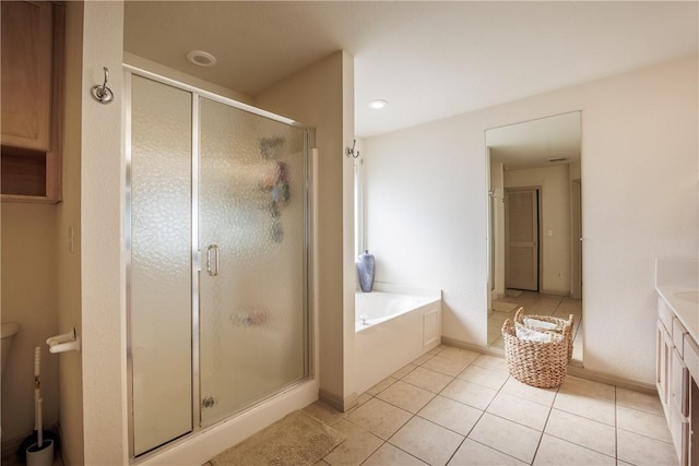 bathroom featuring vanity, shower with separate bathtub, and tile patterned floors