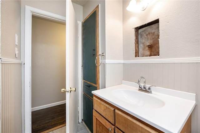 bathroom with wainscoting and vanity