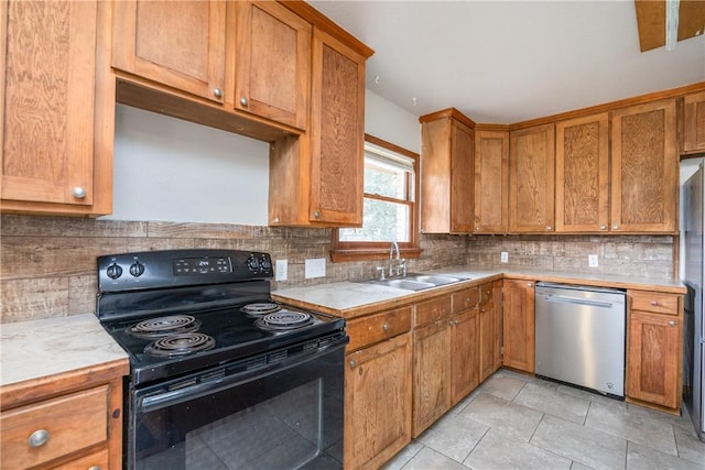 kitchen featuring a sink, black electric range, stainless steel dishwasher, light countertops, and brown cabinets