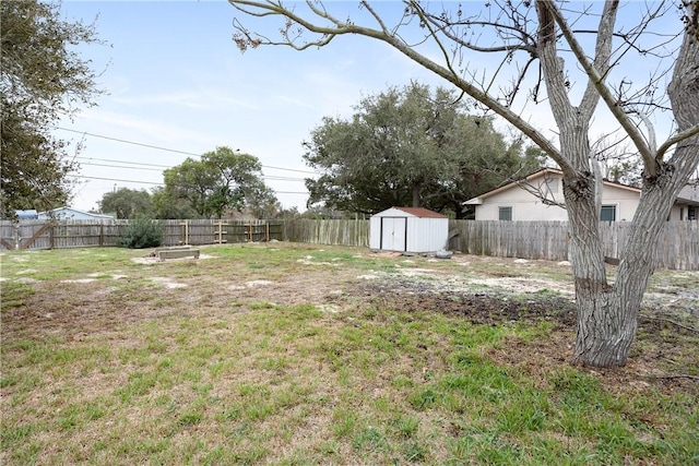 view of yard with a storage shed, a fenced backyard, and an outdoor structure