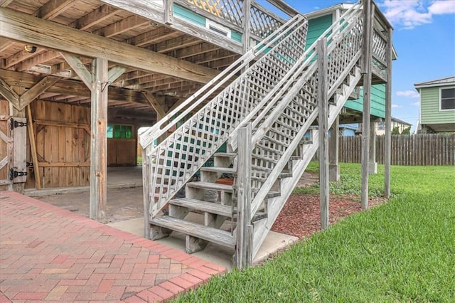 view of patio with stairs and fence