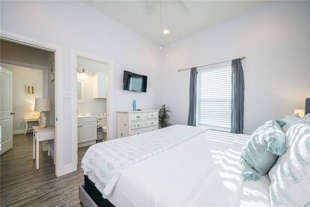 bedroom with connected bathroom and dark hardwood / wood-style flooring