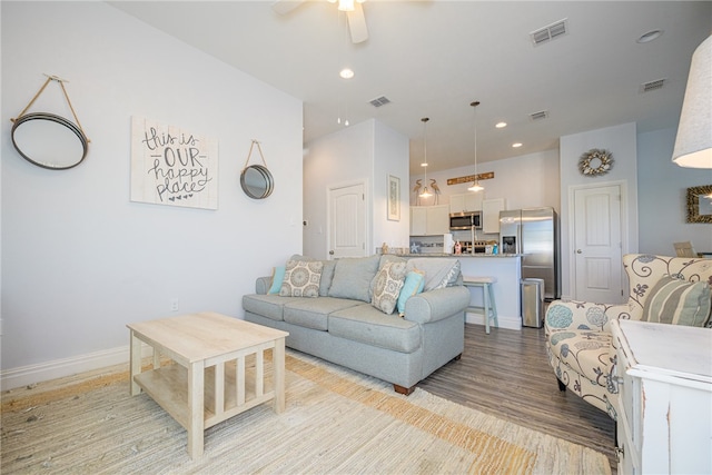 living room featuring light hardwood / wood-style floors and ceiling fan