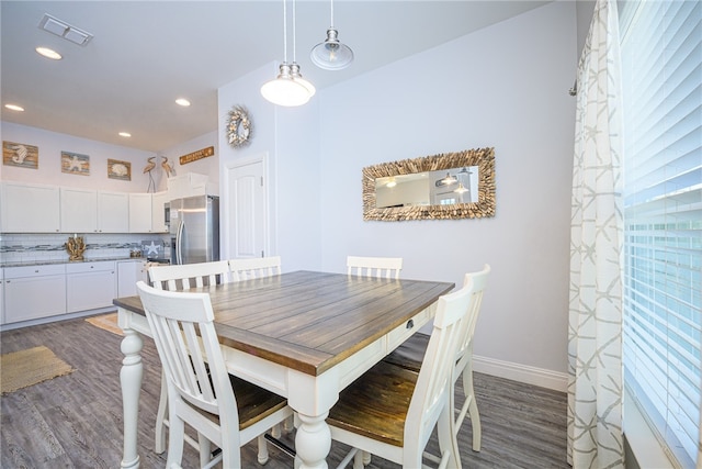 dining space featuring dark wood-type flooring