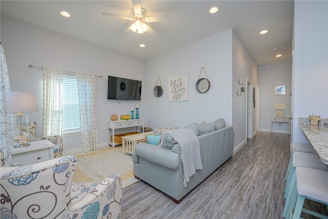 living room featuring ceiling fan and light hardwood / wood-style flooring