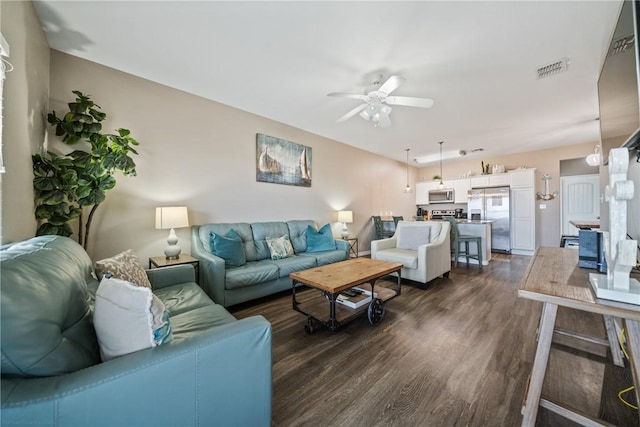 living room featuring dark hardwood / wood-style floors and ceiling fan