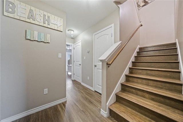 stairs featuring wood-type flooring