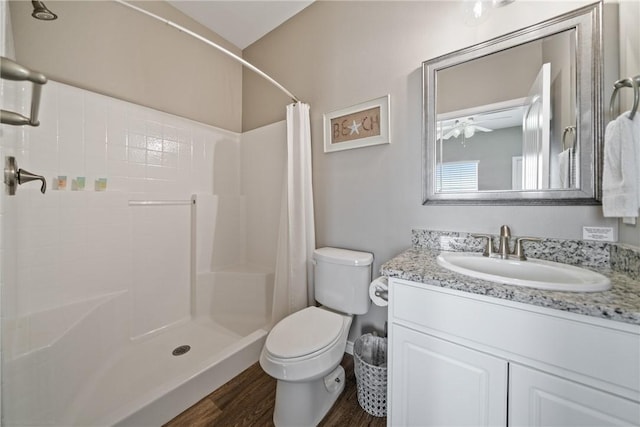 bathroom with vanity, wood-type flooring, toilet, and walk in shower