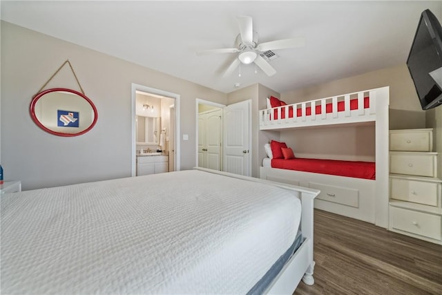 bedroom featuring ceiling fan, dark wood-type flooring, and ensuite bath