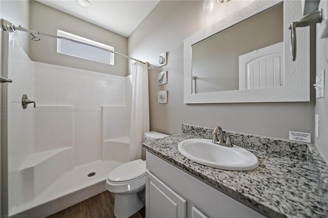 bathroom with hardwood / wood-style flooring, vanity, toilet, and a shower with shower curtain