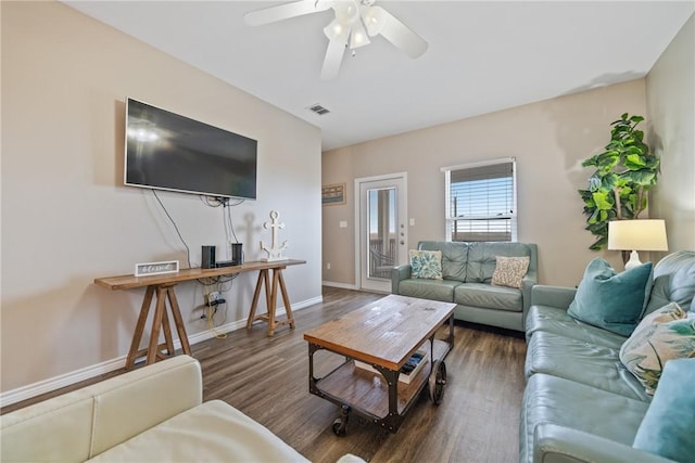 living room with ceiling fan and dark hardwood / wood-style floors