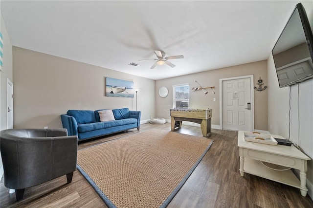 living room featuring hardwood / wood-style floors and ceiling fan