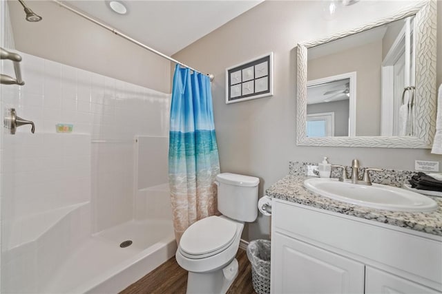 bathroom with a shower with curtain, vanity, toilet, and wood-type flooring