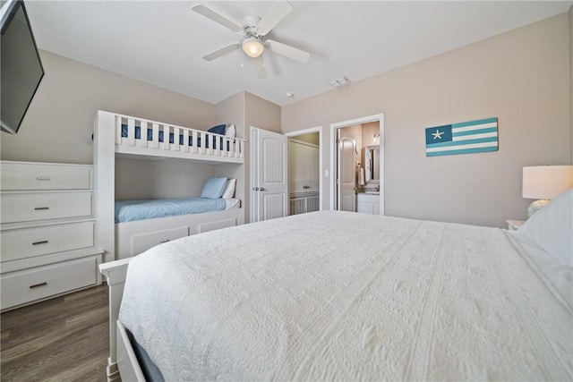 bedroom featuring dark wood-type flooring, ensuite bath, and ceiling fan