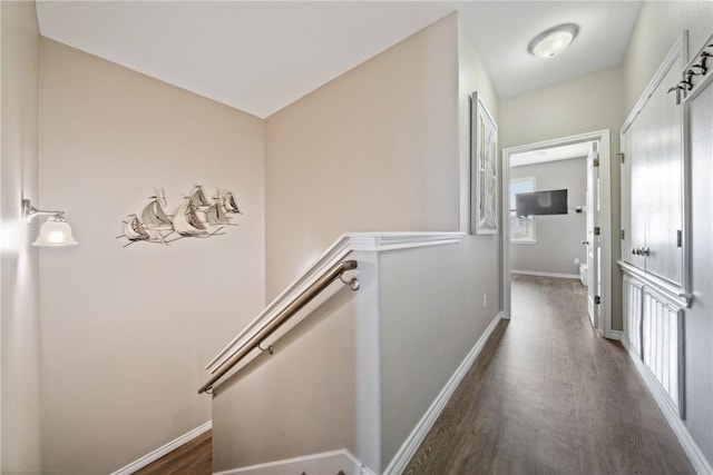 corridor with dark hardwood / wood-style floors