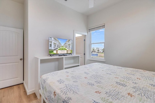 bedroom with ceiling fan and light wood-type flooring