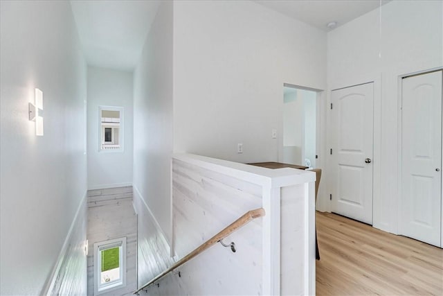 corridor with light hardwood / wood-style flooring