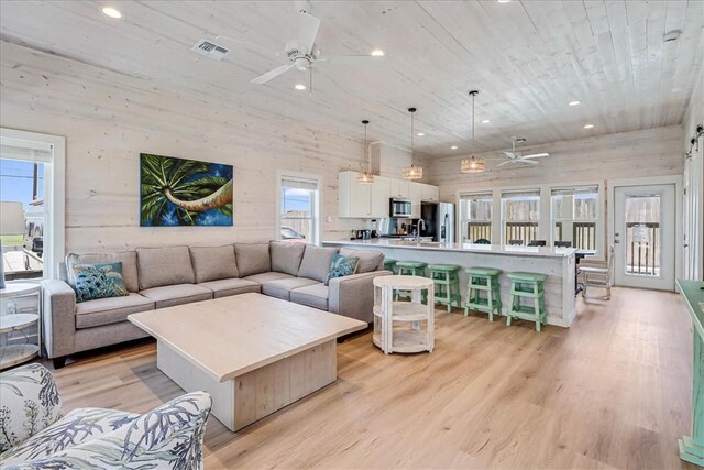 living room with sink, light hardwood / wood-style flooring, ceiling fan, and wood ceiling